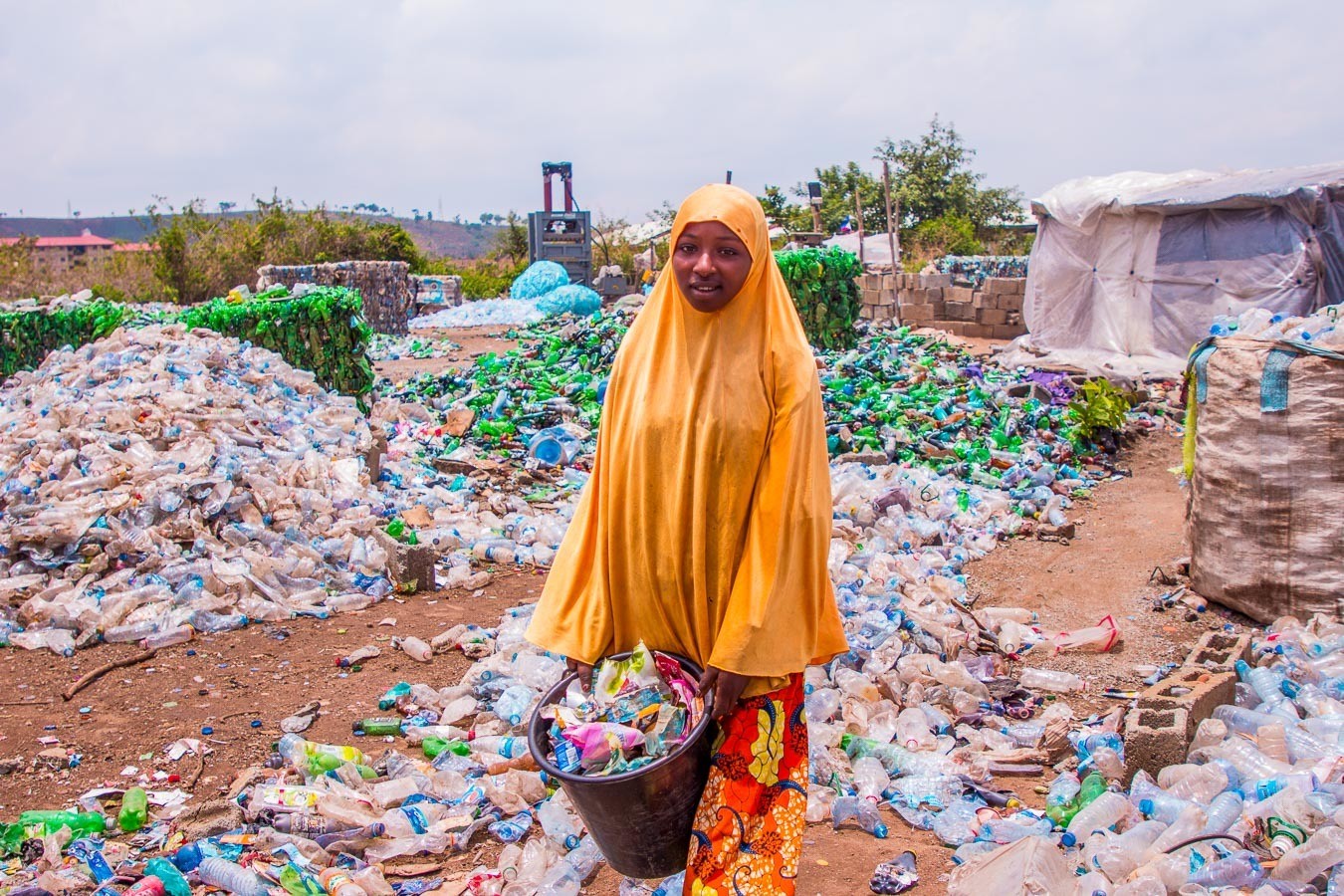 A woman working in a recycling centre helping to reduce plastic pollution in Nigeria